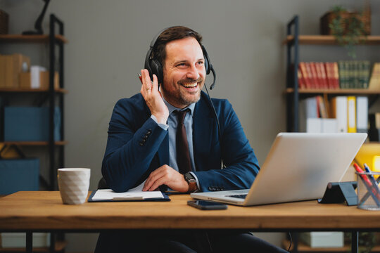 Business professional smiling during a remote meeting with headset