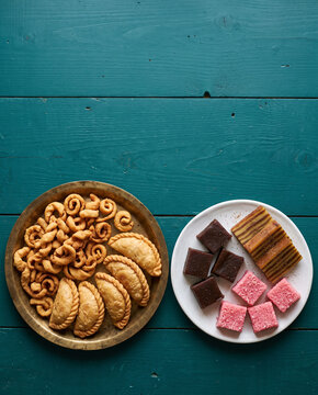 Goan Christmas kuswar sweets platter with kulkuls, neureos, dodol and bebinca, top view with copy space, vertical
