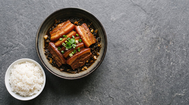 Hakka mei cai kou rou braised pork belly with preserved mustard greens, top view with copy space