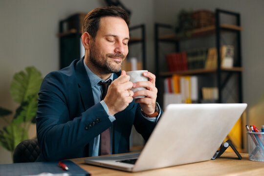 Businessman savoring coffee during a focused work break