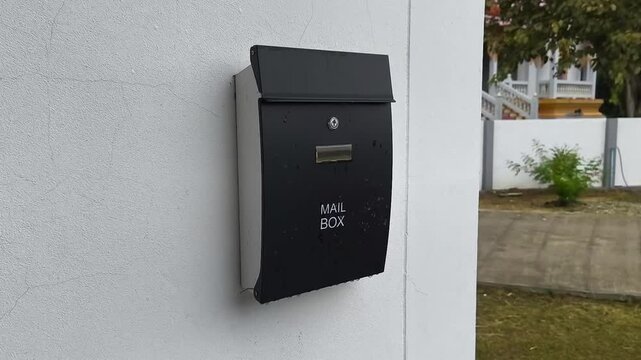 Black mailbox in front of the house