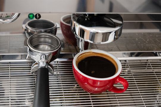Red cup of americano coffee on black background for breakfast.Top view hot black coffee in restaurant make by barista on best of menu in the coffee shop.Refresh menu.