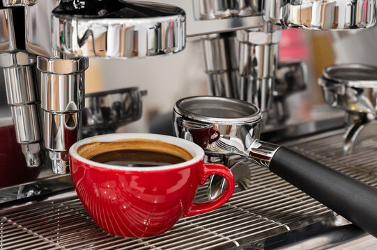 Red cup of americano coffee on black background for breakfast.Top view hot black coffee in restaurant make by barista on best of menu in the coffee shop.Refresh menu.