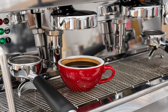 Red cup of americano coffee on black background for breakfast.Top view hot black coffee in restaurant make by barista on best of menu in the coffee shop.Refresh menu.