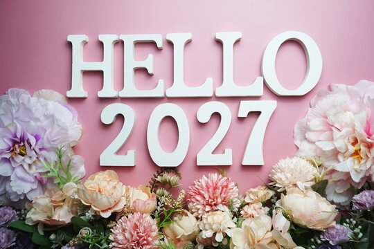 Hello 2027 alphabet letter with flower decoration on pink background