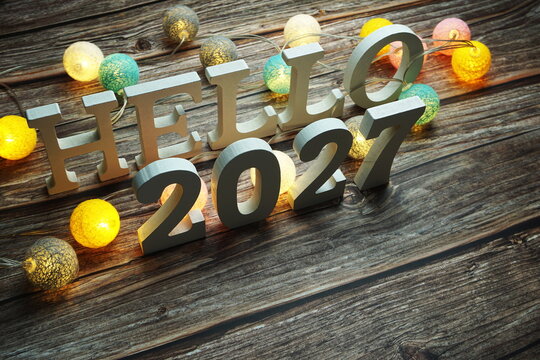 Hello 2027 alphabet letter with cotton ball LED decoration on wooden background