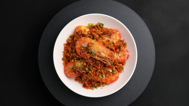 Stir fried river prawn(Giant freshwater prawn) with garlic and salt in white plate.(goong pad prik glua).Top view.	