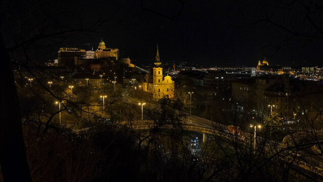 Night panoramic view from the Buda hills with illuminated Buda Castle, historic riverside architecture, the Danube and Hungarian Parliament Building in the distance, Budapest, Hungary.