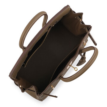 Open taupe structured womens handbag photographed from above, showing a spacious dark interior, zip pocket, double top handles and gold tone hardware on a white background.