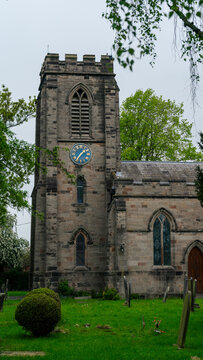 St. Lawrence Church. A church with distinctive stone oars featuring a clock and pointed windows in the English style