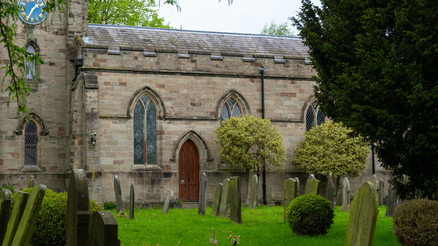 St. Lawrence Church. A church with distinctive stone oars featuring a clock and pointed windows in the English style