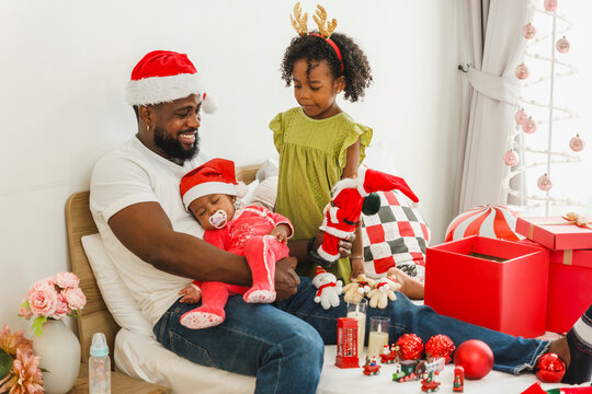 Father and children celebrate Christmas together at home