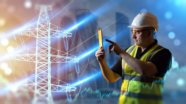 Power grid management, electrical engineer uses a tablet to monitor high voltage transmission lines, energy distribution and smart grid infrastructure.