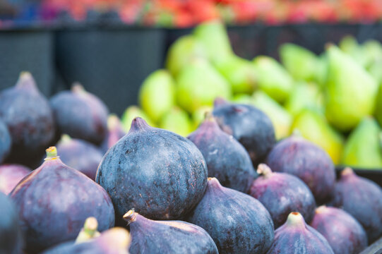 Fresh purple fig harvest display. Organic sweet fruit market pile