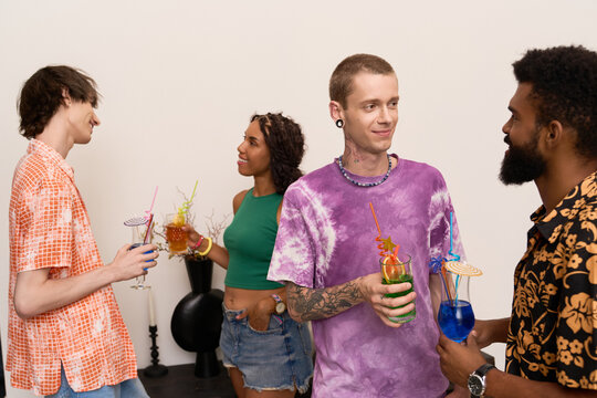 Diverse friends share a colorful toast at a joyful modern party