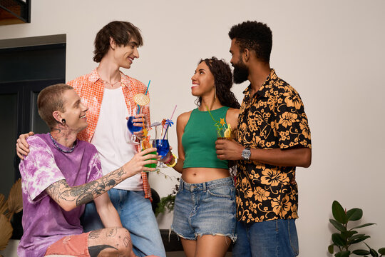 Joyful multiracial friends share a colorful toast at a modern home party