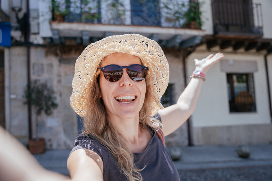 Excited Freckled Expat in Her Forties Taking a Selfie on a Sunny Spanish Street