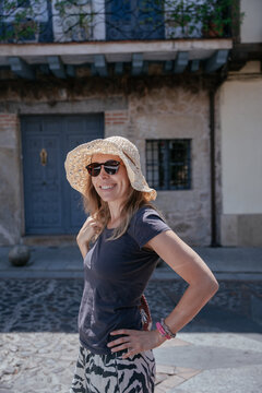 Confident Middle Aged Expat Smiling on a Sunlit Street in a Traditional Spanish Town