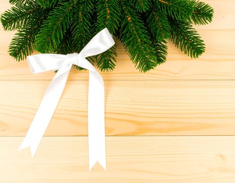 Christmas Bow and Fir Branch Decorating Wooden Surface