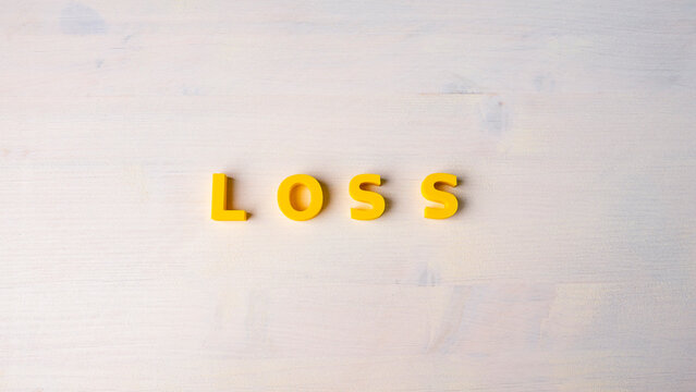Financial loss, business decline and negative results concept with yellow LOSS word