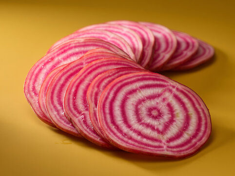 Sliced Chioggia Candy Cane Beet On Warm Yellow Surface