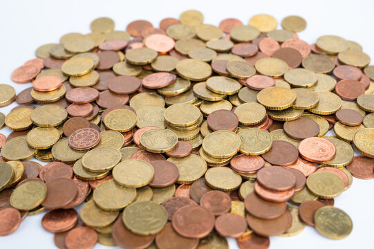 Euro coins lie in a pile on a white surface during a count.