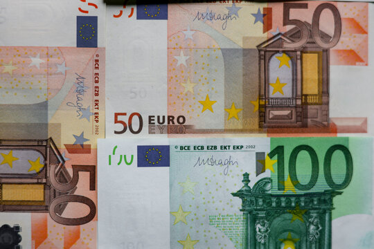 Background of Euro banknotes money. Euro inflation, euro prices increase concept. Finance background of different euro bills. European money. Close-up view of scattered 100 euro banknotes, top view 