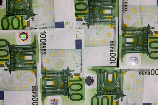 Background of Euro banknotes money. Euro inflation, euro prices increase concept. Finance background of different euro bills. European money. Close-up view of scattered 100 euro banknotes, top view 