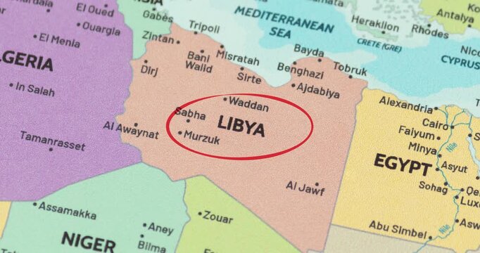 Detailed view of a red circle marking to libya on a modern political world map