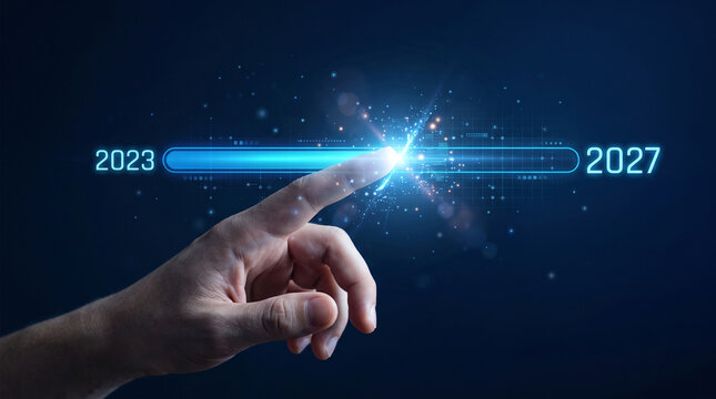 Human finger touching a progress bar from 2023 to 2027, symbolizing future, technology, and advancement.