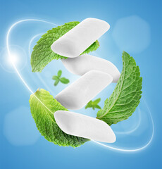 Menthol chewing gum pieces and mint leaves in air against blue background © New Africa