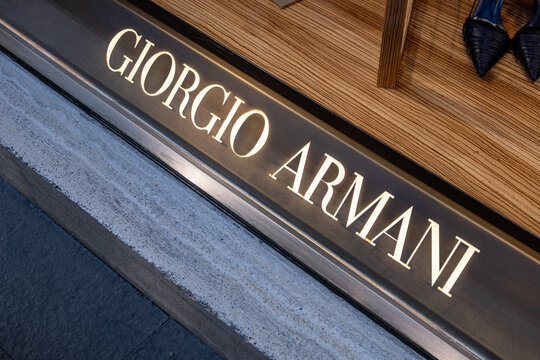 Illuminated designer fashion boutique sign in rome, italy