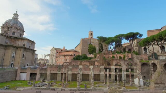 Ancient forum columns line central Rome beneath churches, brick ruins and umbrella pines. Imperial Fora, Roman archaeology, historic architecture, tourism, cultural heritage