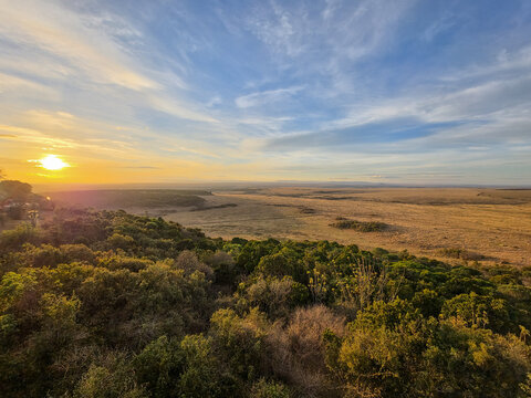 Kenya savanna landscape at sunset beneath an expansive sky