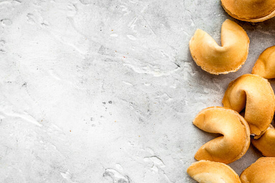 Chinese fortune cookie with prediction on stone background top view mock up