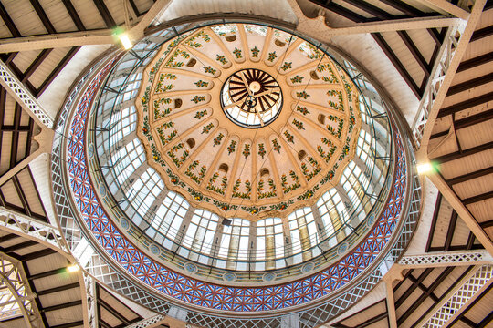 Valencia, Spain - october 01, 2026: art nouveau central dome inside the historic Central Market (Mercado Central) with colorful ceramic tiles, orange tree patterns,  and stained glass windows