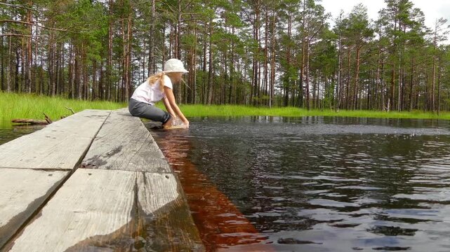 Little girl walks on Swamp Viru Raba in Estonia
