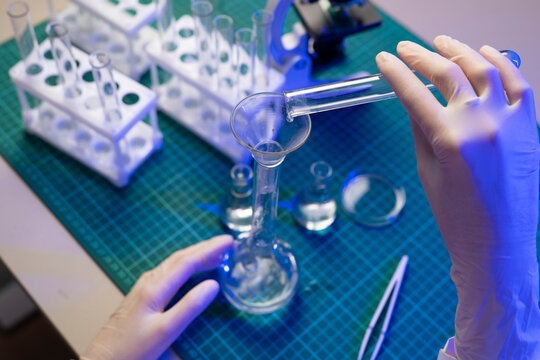 Scientist carefully filters sample through funnel during alternative protein source laboratory research