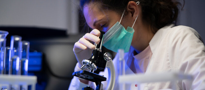 Medical Student Concentrating On Microscope Analysis During University Laboratory Practical