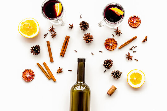 Ingredients for mulled wine. Wine in bottle, spices cinnamon and badian, citrus fruits on white background top view