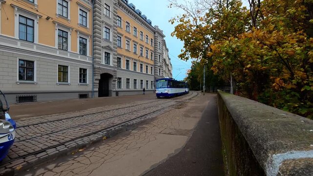 Tram travels through historic Riga street in autumn, Riga Latvia