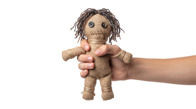 Hand holding creepy voodoo doll on transparent background