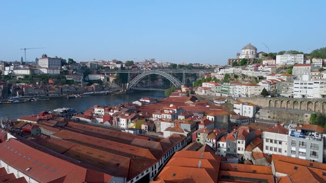 An aerial shot of Red-Tiled Rooftops and Dom Lu&iacute;s I Bridge Over Porto