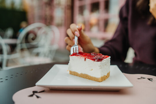Berry-topped cheesecake being enjoyed at a cafe
