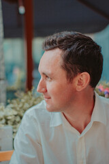 Close Up Side Profile Portrait of Confident Businessman Outside Modern Glass Office Building © Daria