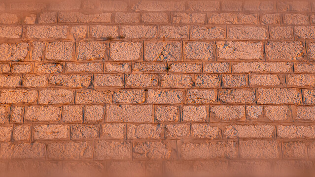 View of the textured stone masonry wall during the golden hour