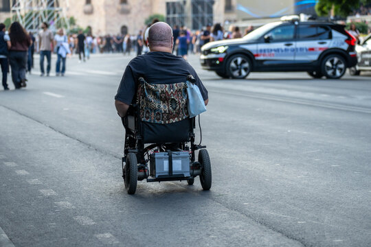 Moving on a wheelchair on the city street