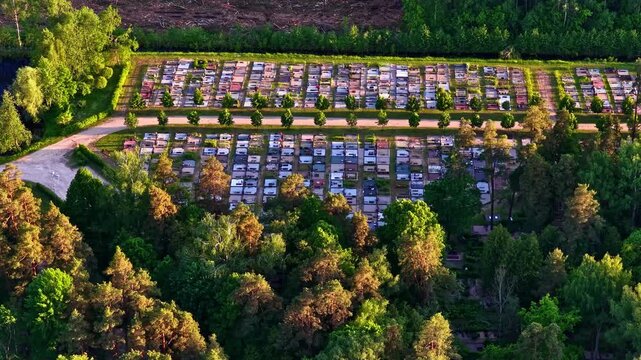 Aerial view of the cemetery in Jelgava surrounded by dense forest with rows of tombstones and pathways in Jelgava, Latvia.
