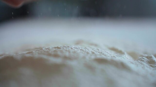 Soft flour swirls down in slow motion. Red bowl pours its contents. Dusty kitchen scene, calm and quiet. Perfect for culinary or baking projects. No people, no animals, no plants shown