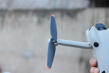 Close Up View Of Drone Propeller Blade Mounted On Motor Arm Held Outdoors © Gatot